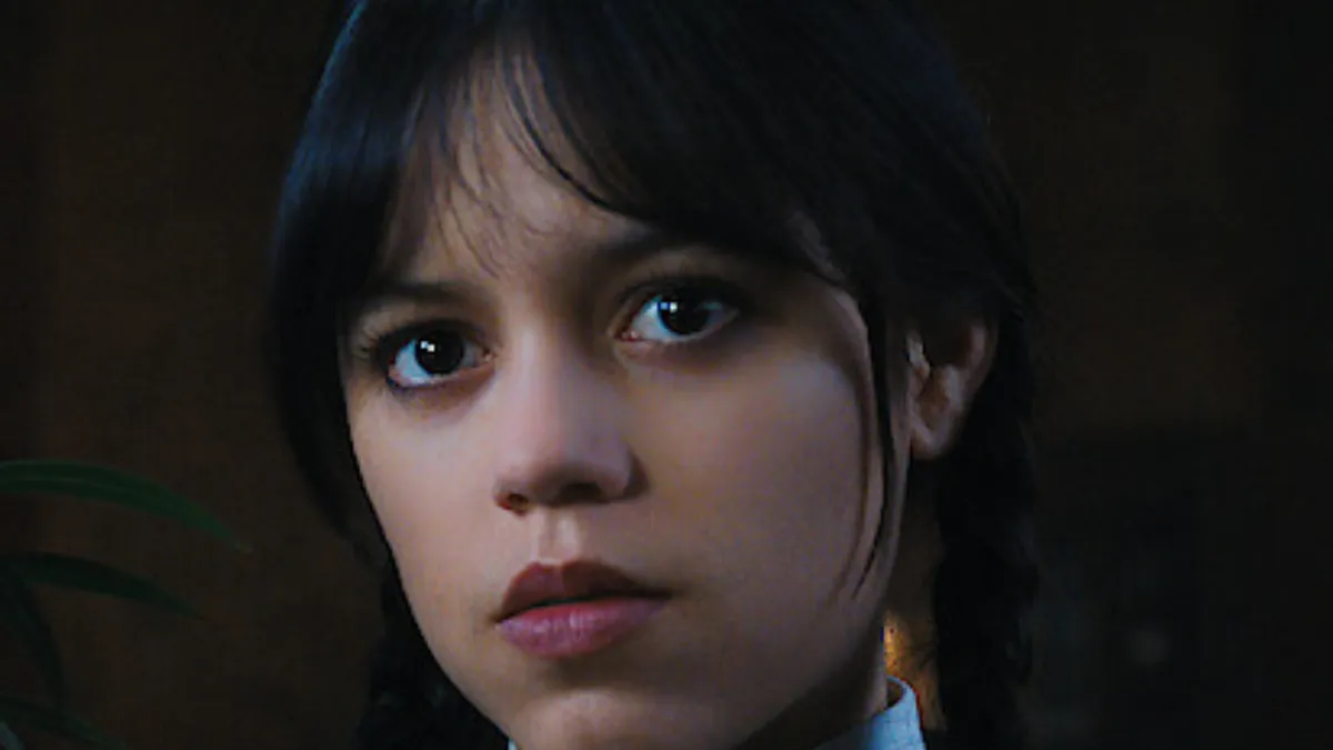 Close-up of Wednesday Addams makeup showing pale skin, dark eyes, and soft goth expression